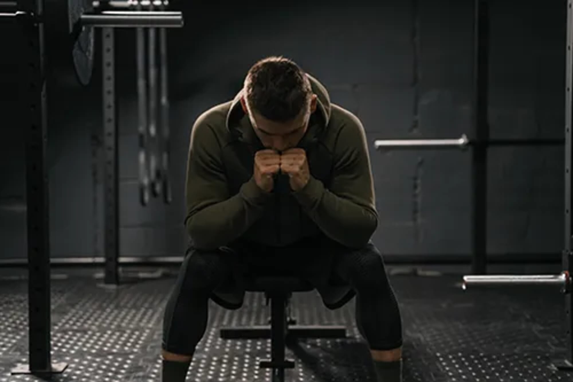 strong-sporty-man-sitting-on-gym-bench-suffering-breakdown-to-overcome-demotivation-sport-concept